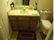 Bathroom with a toilet, sink, and vanity at 10407 Sw 85Th Ct, Ocala, FL 34481