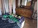 Bedroom with wooden dresser and dark-colored bedding at 10407 Sw 85Th Ct, Ocala, FL 34481