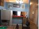 Dining area with kitchen pass-through and rocking chair at 10407 Sw 85Th Ct, Ocala, FL 34481