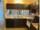 Kitchen with dark brown cabinets, stainless steel appliances, and a double sink at 10407 Sw 85Th Ct, Ocala, FL 34481