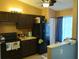 Kitchen with dark brown cabinets, stainless steel appliances, and a double sink at 10407 Sw 85Th Ct, Ocala, FL 34481
