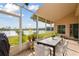 Screened-in porch overlooking a lake, with table and chairs at 213 Largo Dr, Poinciana, FL 34759