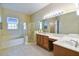 Bathroom with double vanity, shower and bathtub at 256 New River Dr, Poinciana, FL 34759