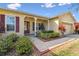 House exterior with landscaped yard and brick walkway at 256 New River Dr, Poinciana, FL 34759
