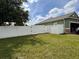 Private backyard with a white vinyl fence and grassy area at 2605 Coldstream Ct, Kissimmee, FL 34743