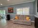 Relaxing living room featuring a comfy couch and large window at 2605 Coldstream Ct, Kissimmee, FL 34743