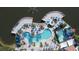 Expansive resort-style pool with a waterslide, surrounded by palm trees and lounge chairs at 2627 Bugatti Ct, Kissimmee, FL 34746