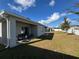 Large backyard with covered patio and grassy area at 2843 Turnstone Run, Harmony, FL 34773