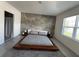 Main bedroom with platform bed and ensuite bathroom at 2843 Turnstone Run, Harmony, FL 34773