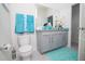 Bathroom with gray vanity and teal towels at 2937 Hooded Crane Cv, Harmony, FL 34773