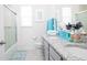 Bathroom with granite countertop and teal accents at 2937 Hooded Crane Cv, Harmony, FL 34773