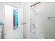 Bathroom with tub and shower, and teal accents at 2937 Hooded Crane Cv, Harmony, FL 34773