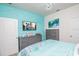 Bedroom with teal accent wall and gray dresser at 2937 Hooded Crane Cv, Harmony, FL 34773