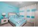 Spacious bedroom with Tiffany & Co. bedding and blue accents at 2937 Hooded Crane Cv, Harmony, FL 34773