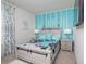 Bedroom with white and gray furniture and teal accents at 2937 Hooded Crane Cv, Harmony, FL 34773