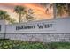 Harmony West community entrance sign with stone and landscaping at 2937 Hooded Crane Cv, Harmony, FL 34773