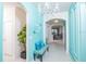 Elegant entryway with teal walls, chandelier, and seating at 2937 Hooded Crane Cv, Harmony, FL 34773