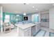 Island kitchen features granite countertops and modern cabinetry at 2937 Hooded Crane Cv, Harmony, FL 34773