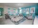 Living room boasts a Tiffany & Co themed wall and comfy seating at 2937 Hooded Crane Cv, Harmony, FL 34773