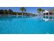 Refreshing community pool with palm trees and lounge chairs at 2937 Hooded Crane Cv, Harmony, FL 34773