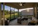 Relaxing screened porch with wicker furniture and ceiling fan at 2937 Hooded Crane Cv, Harmony, FL 34773