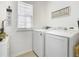 Laundry room with washer, dryer, and ample storage at 321 Briarbrook Ln, Haines City, FL 33844