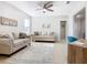 Bright living room featuring beige sofas, a rug, and a ceiling fan at 321 Briarbrook Ln, Haines City, FL 33844