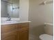 Bathroom with shower, toilet, and wood vanity at 34 Pine Island Cir, Kissimmee, FL 34743