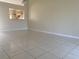 Dining area with light walls, tiled floors, and kitchen pass-through at 34 Pine Island Cir, Kissimmee, FL 34743