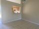 Dining area with light walls, tiled floors, and kitchen pass-through at 34 Pine Island Cir, Kissimmee, FL 34743