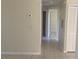 Clean hallway with tile floors and access to bedrooms and bathroom at 34 Pine Island Cir, Kissimmee, FL 34743