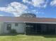 House exterior with screened porch and yard at 34 Pine Island Cir, Kissimmee, FL 34743