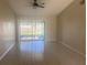 Bright living room featuring tile flooring and sliding glass doors to a patio at 34 Pine Island Cir, Kissimmee, FL 34743