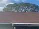 Brown asphalt shingle roof in good condition at 34 Pine Island Cir, Kissimmee, FL 34743