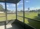 Screened porch with view of pond and neighborhood at 34 Pine Island Cir, Kissimmee, FL 34743