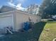 Side view of house with a garage and some building materials at 449 Heather Hill Blvd, Davenport, FL 33837
