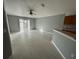 Living room with tile flooring, sliding doors, and kitchen bar at 449 Heather Hill Blvd, Davenport, FL 33837