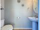 Small half bathroom with pedestal sink and toilet at 4626 Terrasonesta Dr, Davenport, FL 33837