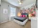 Bedroom with floral wall mural and ceiling fan at 4626 Terrasonesta Dr, Davenport, FL 33837