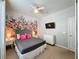 Bedroom with floral accent wall and TV at 4626 Terrasonesta Dr, Davenport, FL 33837