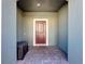 Front entry with a dark brown door and brick flooring at 4626 Terrasonesta Dr, Davenport, FL 33837