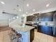 Island kitchen with granite countertops, dark cabinets, and stainless steel appliances at 4626 Terrasonesta Dr, Davenport, FL 33837