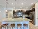 Modern kitchen with curved island, granite countertops, and stainless steel appliances at 4626 Terrasonesta Dr, Davenport, FL 33837