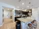 Open concept kitchen with island, granite countertops, and stainless steel appliances at 4626 Terrasonesta Dr, Davenport, FL 33837