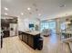 Open kitchen with island and stainless steel appliances at 4626 Terrasonesta Dr, Davenport, FL 33837
