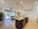 Kitchen with island, stainless steel appliances, and view into Gathering room and pool at 4626 Terrasonesta Dr, Davenport, FL 33837
