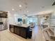 Open concept kitchen with island, stainless steel appliances, and granite countertops at 4626 Terrasonesta Dr, Davenport, FL 33837