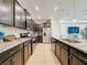 Modern kitchen featuring dark wood cabinets, granite countertops, and stainless steel appliances at 4626 Terrasonesta Dr, Davenport, FL 33837