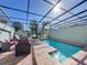 Relaxing pool area with covered patio and lounge chairs at 4626 Terrasonesta Dr, Davenport, FL 33837