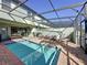 Private screened pool and patio area with lounge chairs at 4626 Terrasonesta Dr, Davenport, FL 33837